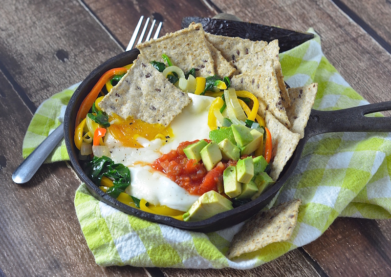 This veggie lovers huevos rancheros tops delicious veggies with a perfectly poached egg.