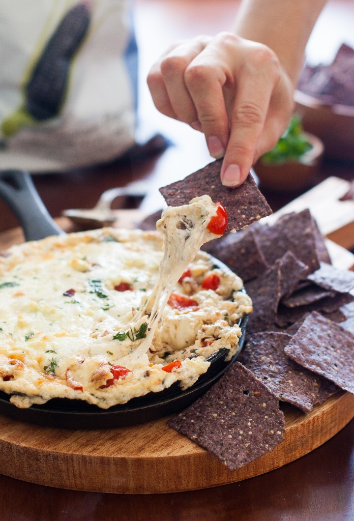 Hearty blue corn Way Better Snacks are the perfect dipper for this hot tomato, bacon, and blue cheese dip. Perfect party appetizer!