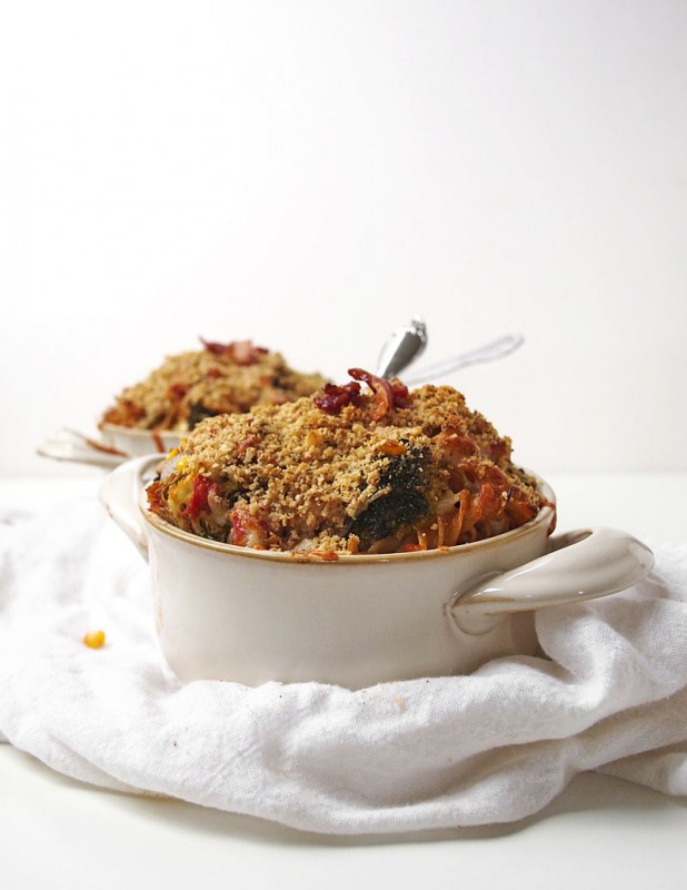 Whole wheat pasta, loads of veggies, a crunchy top, and a bit of bacon make this weeknight meal a way better winner.