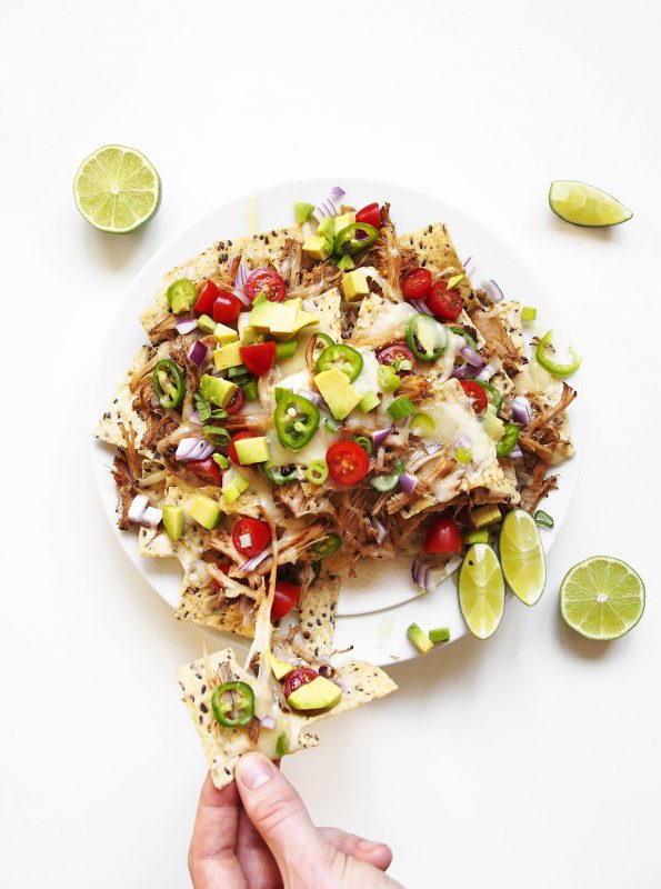 Slow roasted pork, spicy jalapeños, a kick of citrusy lime... we're cooking up a way better nacho recipe.