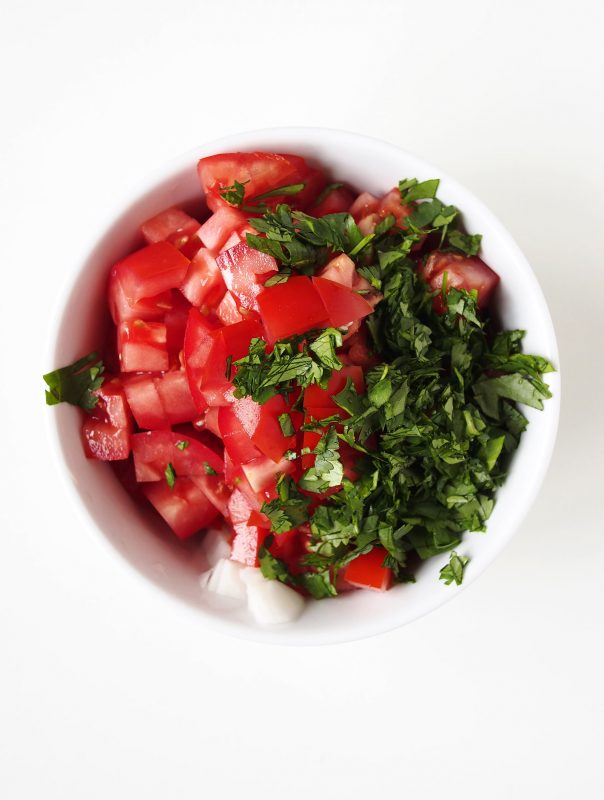 Pico de gallo with fresh, juicy tomatoes, chopped onion and herbs is the perfect topping for all your summer recipes.